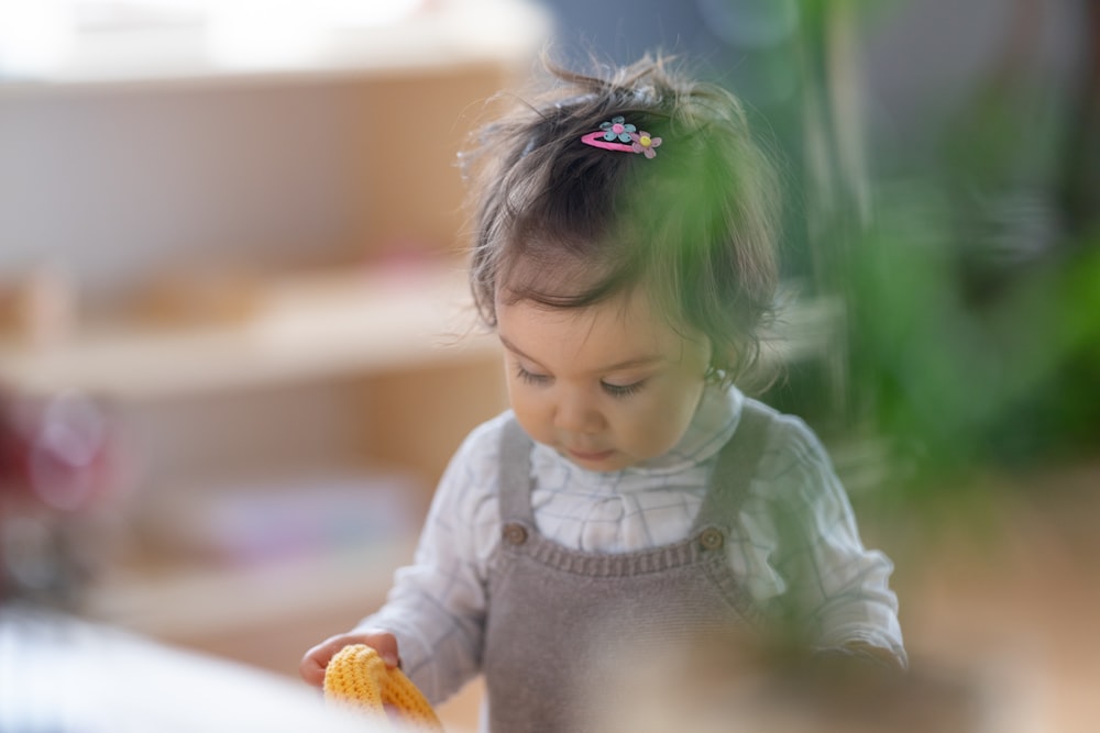 a little girl with a flower in her hair