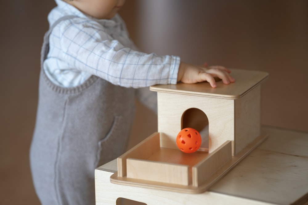 a person touching a toy duck