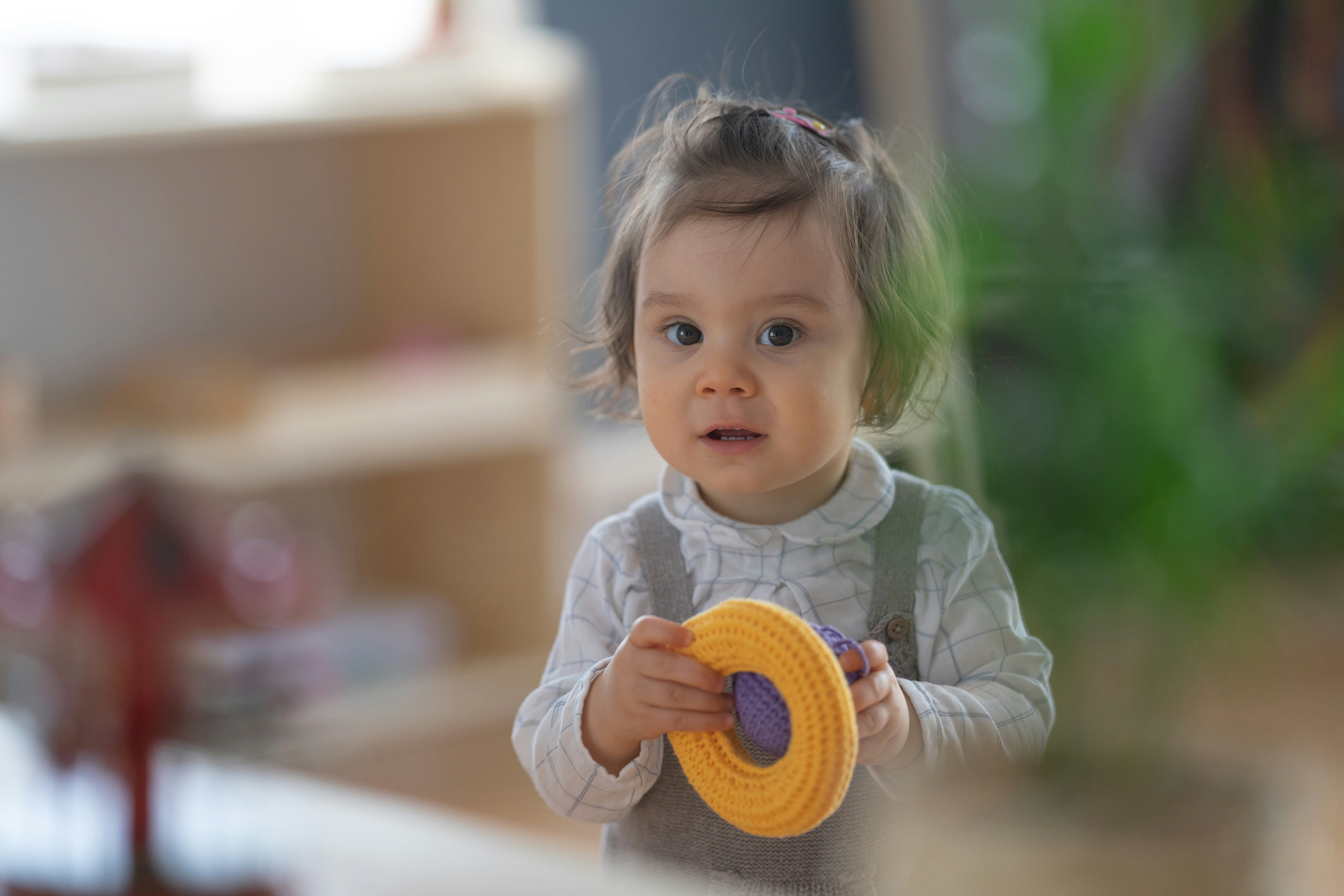 a baby holding a toy