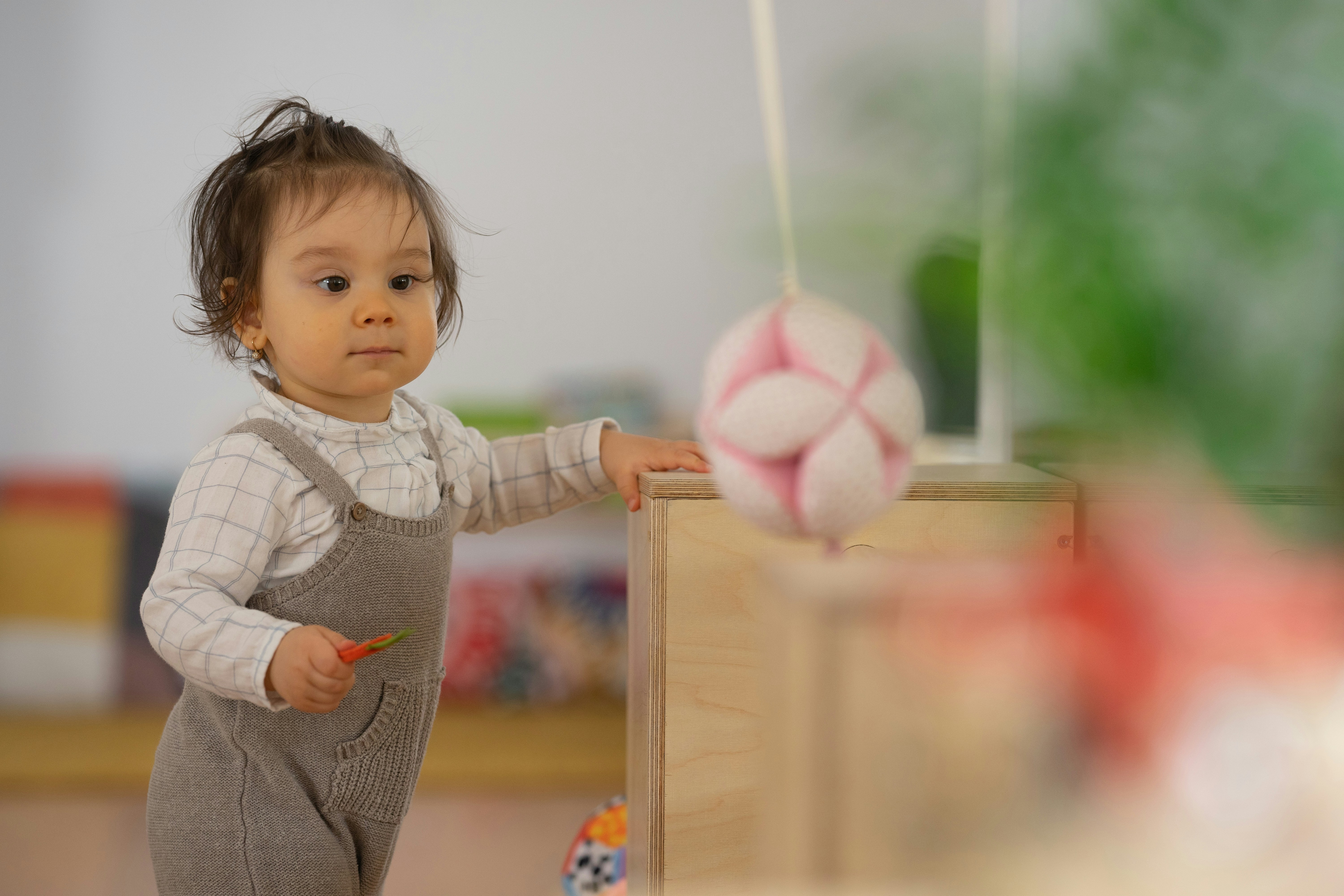 a baby holding a balloon
