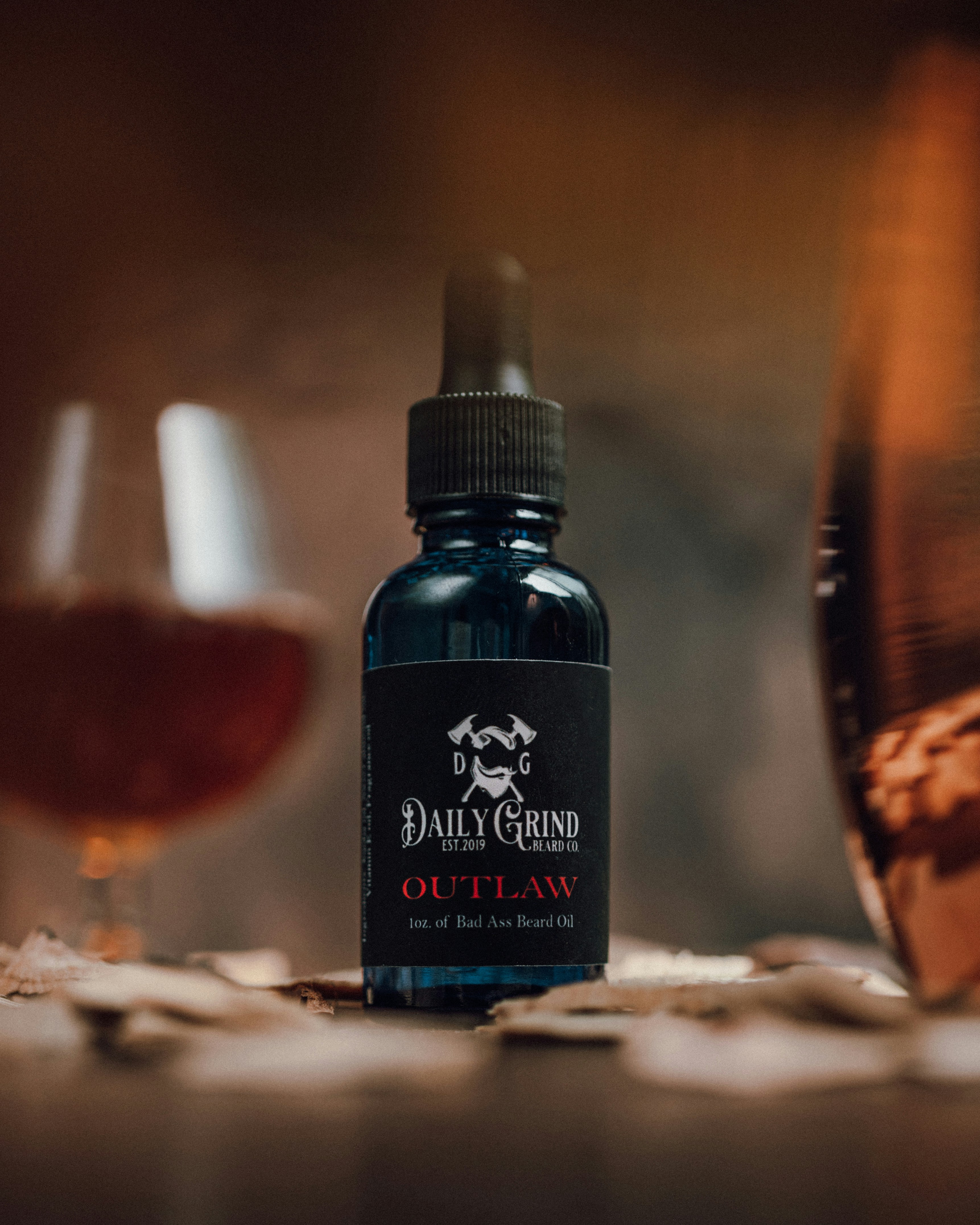 Product photo of Outlaw Beard Oil by Daily Grind Beard Co. Product Photography by branding photographer Lance Reis in Portland Oregon. Elements of Whiskey and Wood were added to visually showcase the scents you can expect with Outlaw. Did you discover us here? Say hi on insta: Kickassdesigns & daily_grind_beard_co