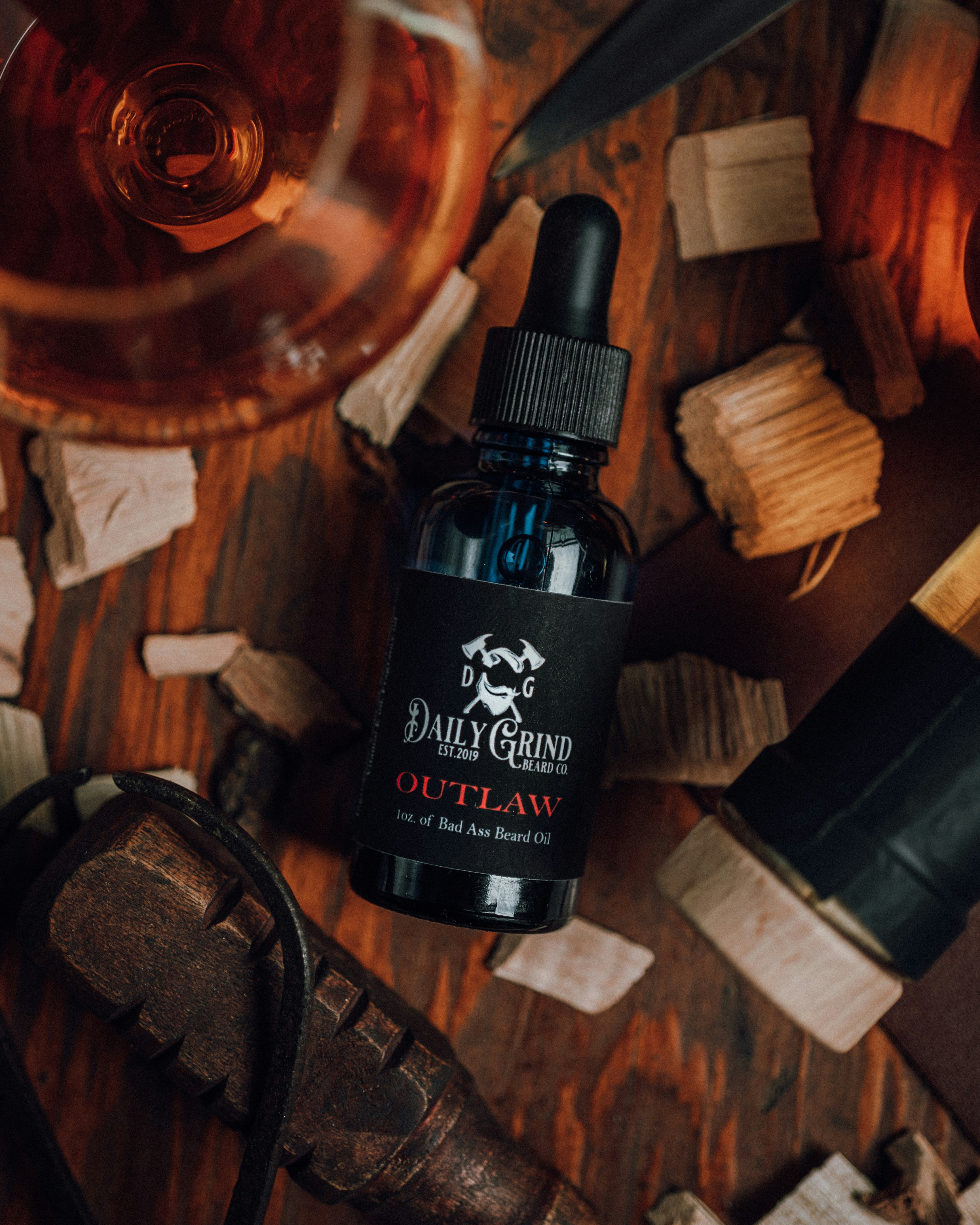 Product photo of Outlaw Beard Oil by Daily Grind Beard Co. Product Photography by branding photographer Lance Reis in Portland Oregon. Elements of Whiskey and Wood were added to visually showcase the scents you can expect with Outlaw. Did you discover us here? Say hi on insta: Kickassdesigns & daily_grind_beard_co