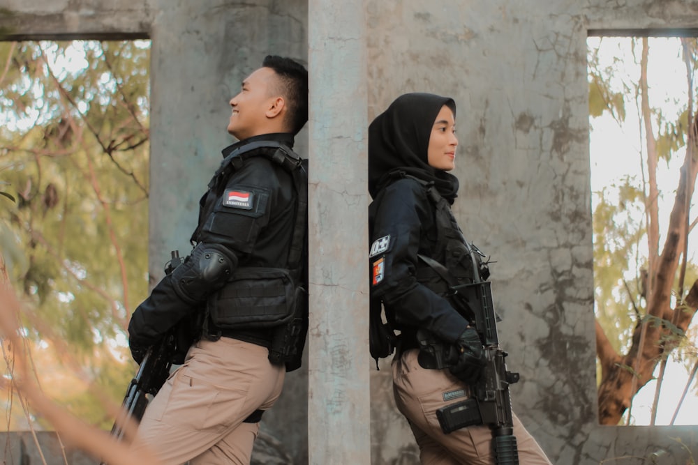 a man and woman in black uniforms
