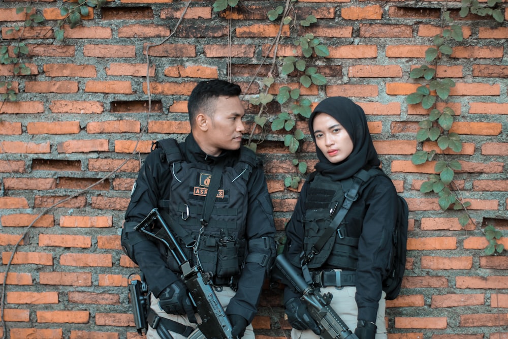 a man and woman standing next to each other and looking at the camera