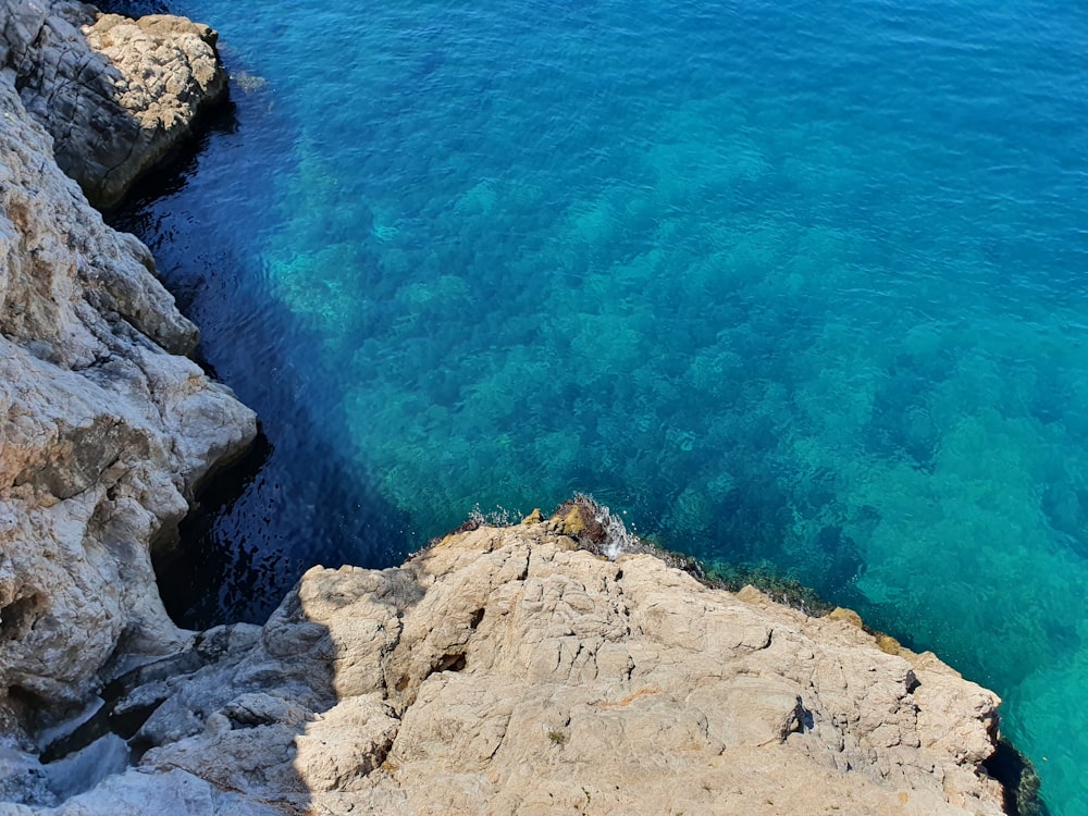 a rocky beach with blue water