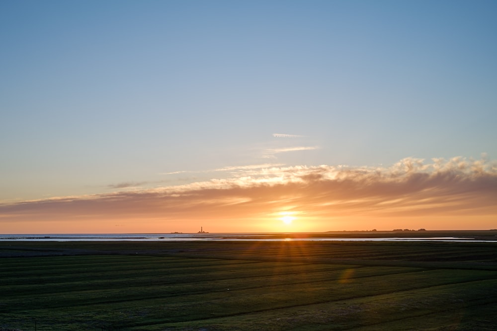 a sunset over a field