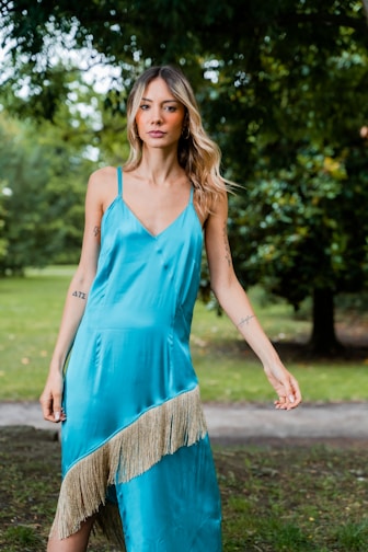 A woman showcasing a chic dress in a bright park.