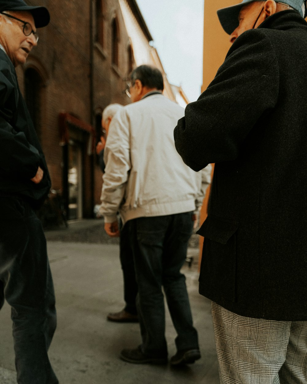 a group of men standing on a sidewalk