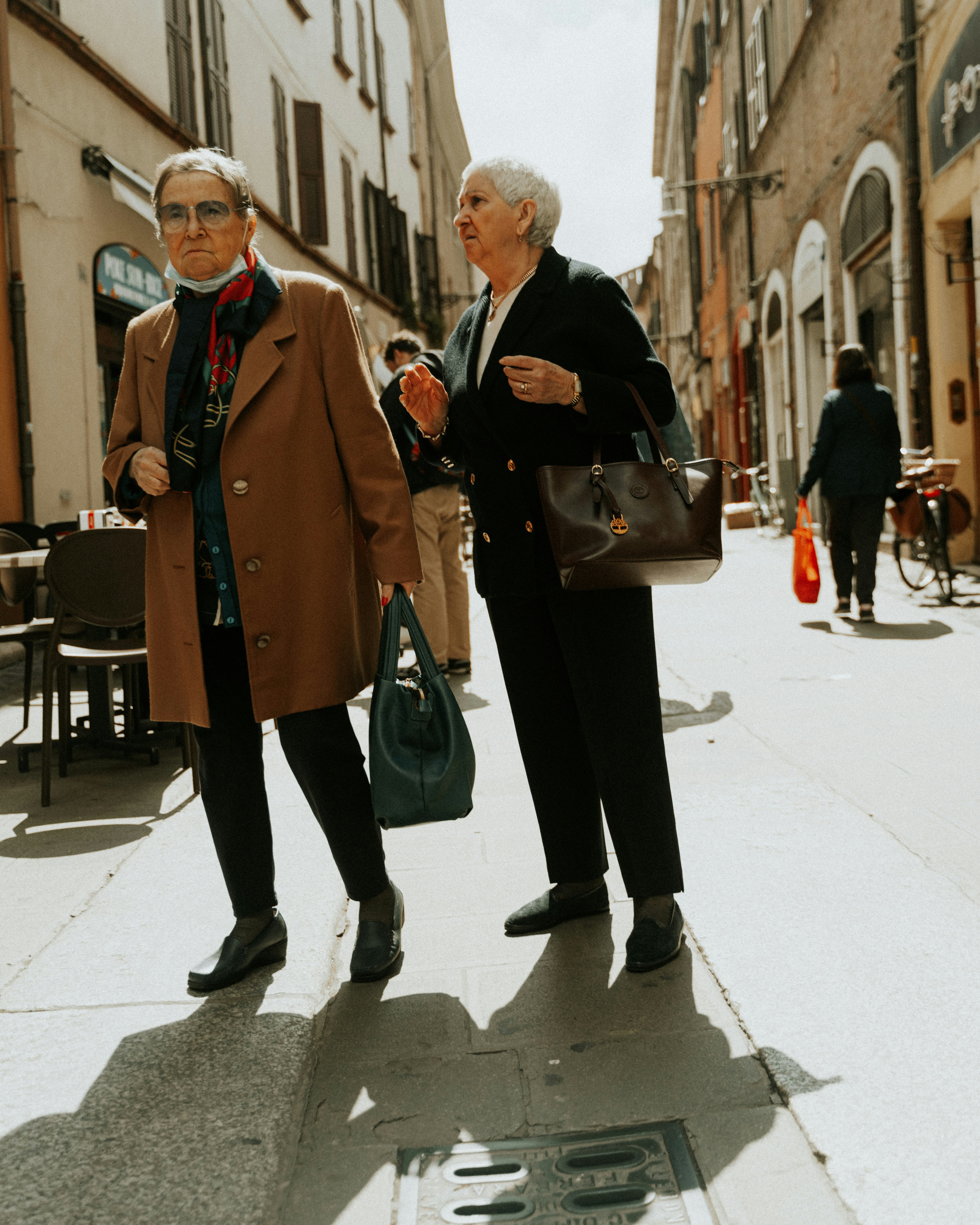a man and woman walking down a street