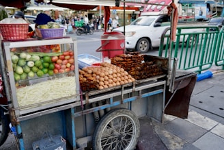A bustling tuk tuk food cart adorned with colorful spices and fresh ingredients.