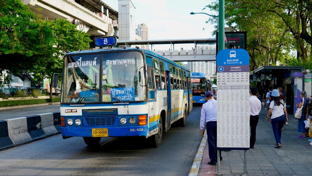 a bus picking up passengers at a bus stop
