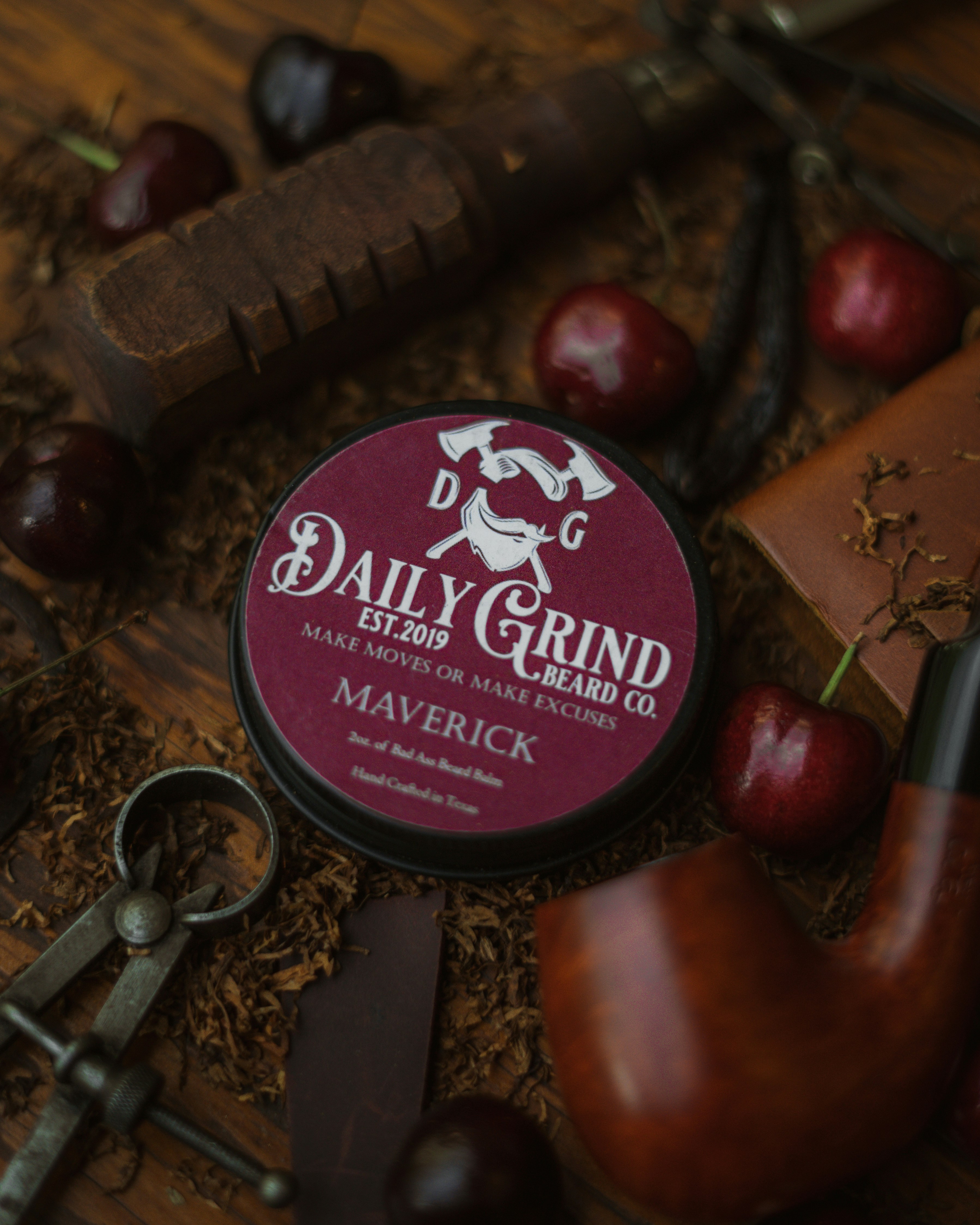 Product photo of Maverick Beard Balm by Daily Grind Beard Co. Product Photography by branding photographer Lance Reis in Portland Oregon. Elements of Tobacco, Wood, Cherry, and Vanilla were added to visually showcase the scents you can expect with Maverick. Did you discover us here? Say hi on insta: Kickassdesigns & daily_grind_beard_co