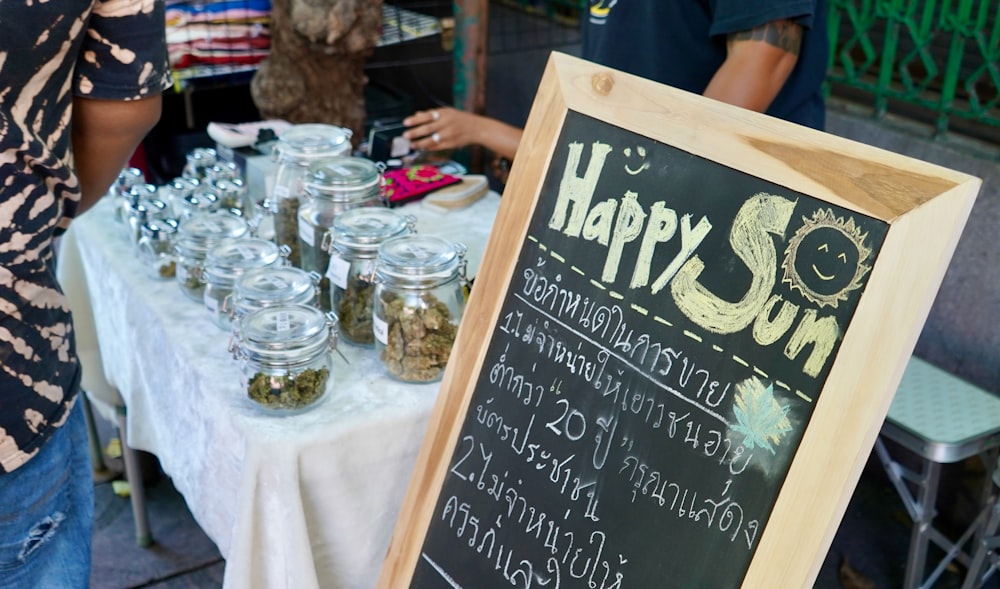 a table with a sign and glasses on it