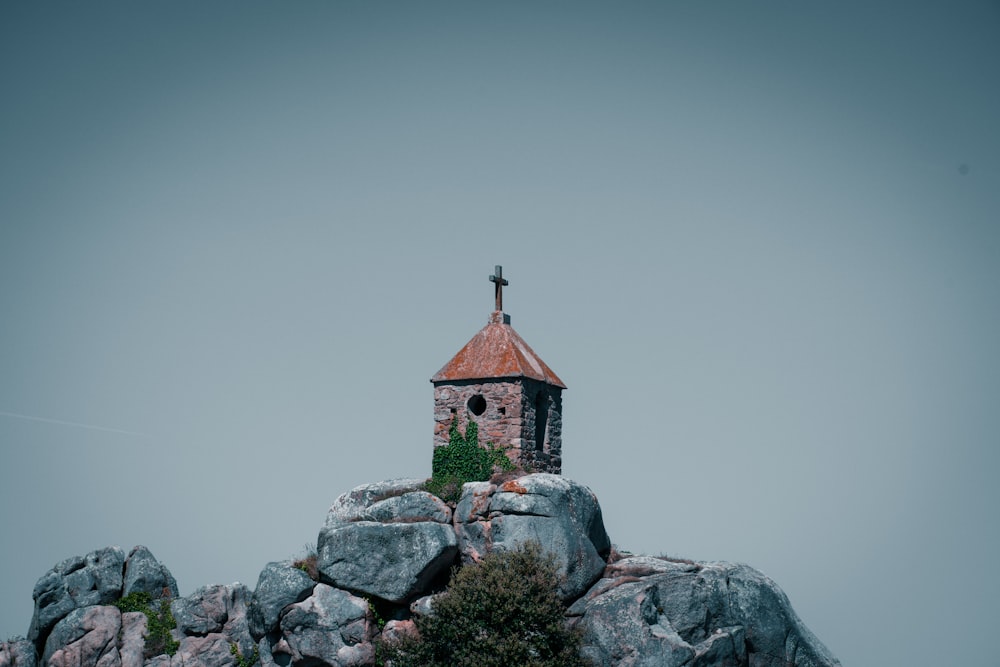 a small building on top of a rock