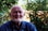 a man standing in front of a bush