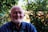a man standing in front of a bush