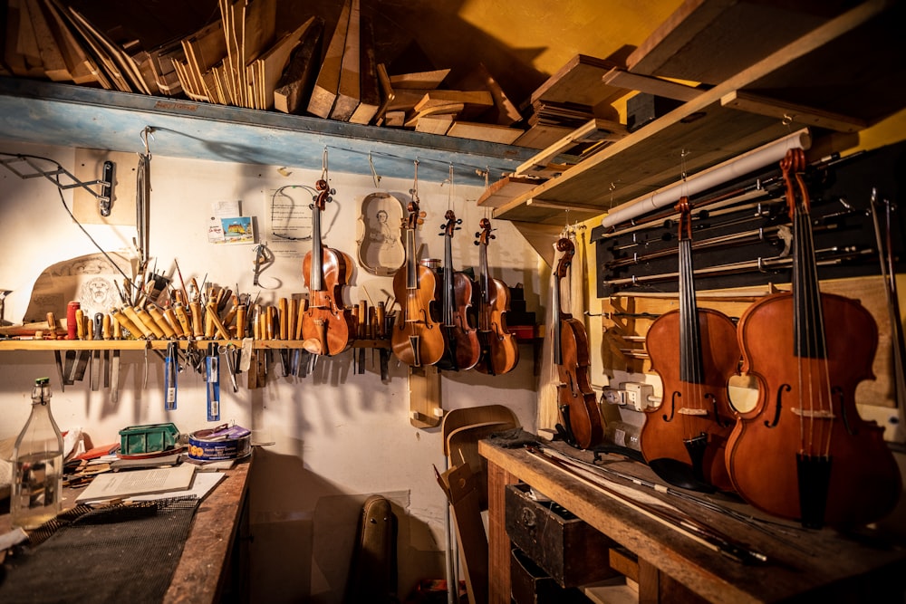 a room with many guitars on the wall