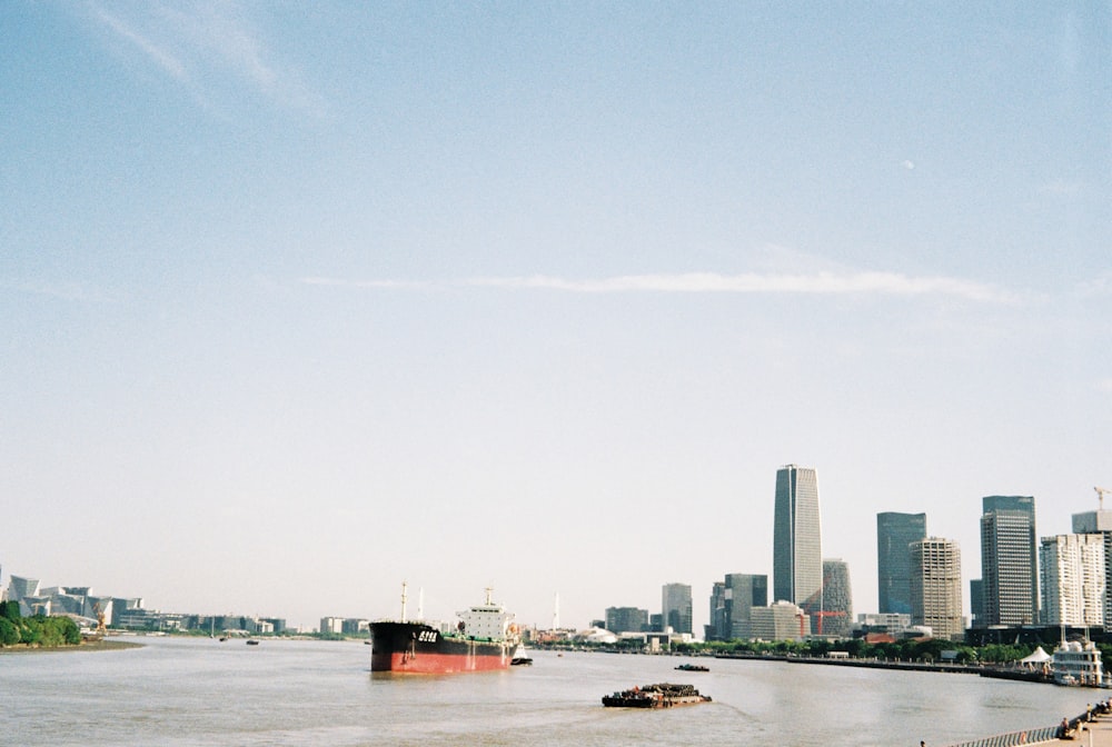 a city skyline with a body of water in the foreground