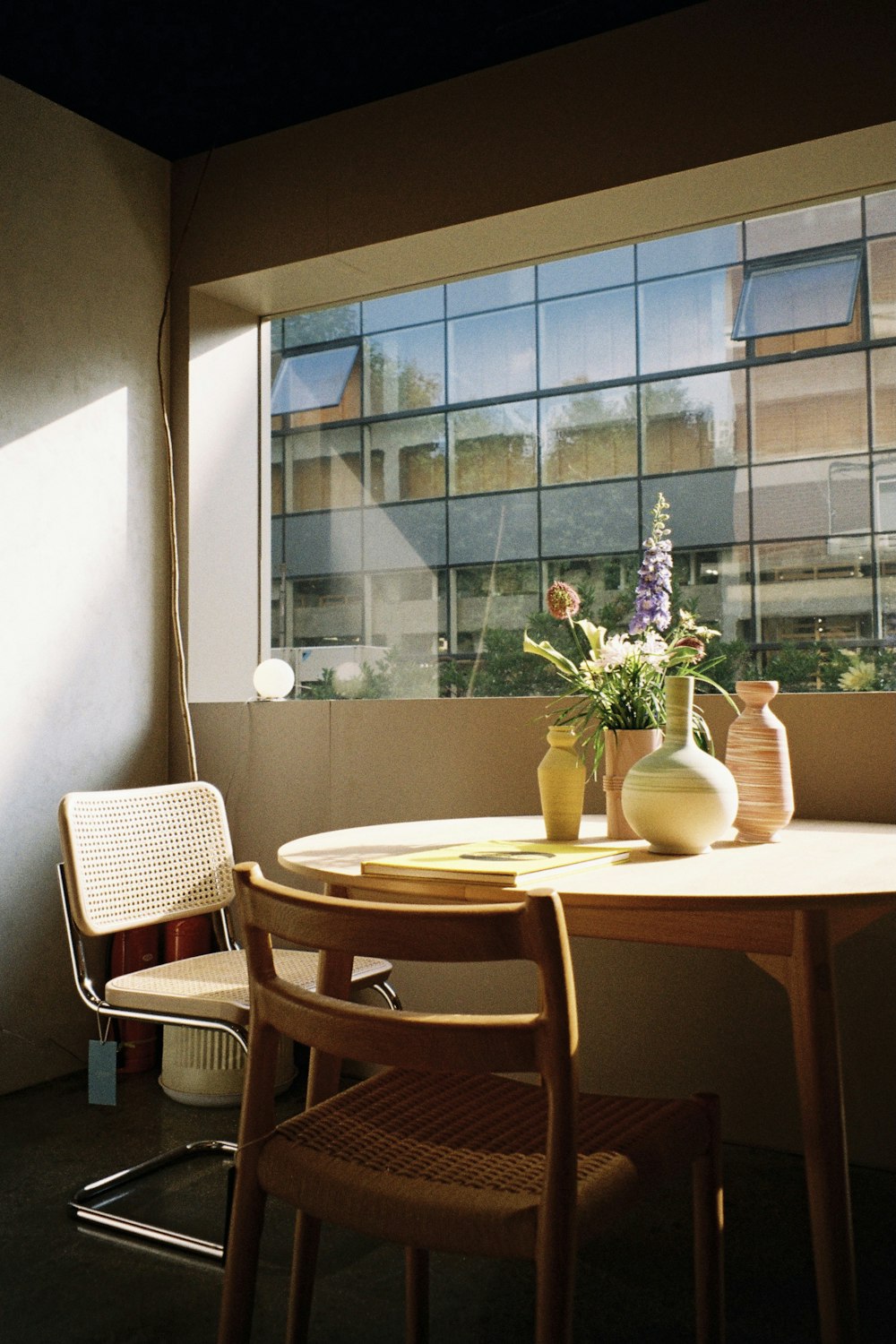 a table with chairs and vases