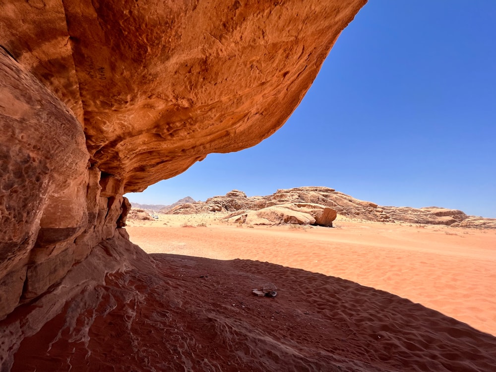 a desert landscape with a rock arch
