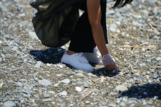 a person's legs and feet in the sand