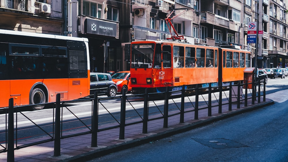 a couple of buses on a city street