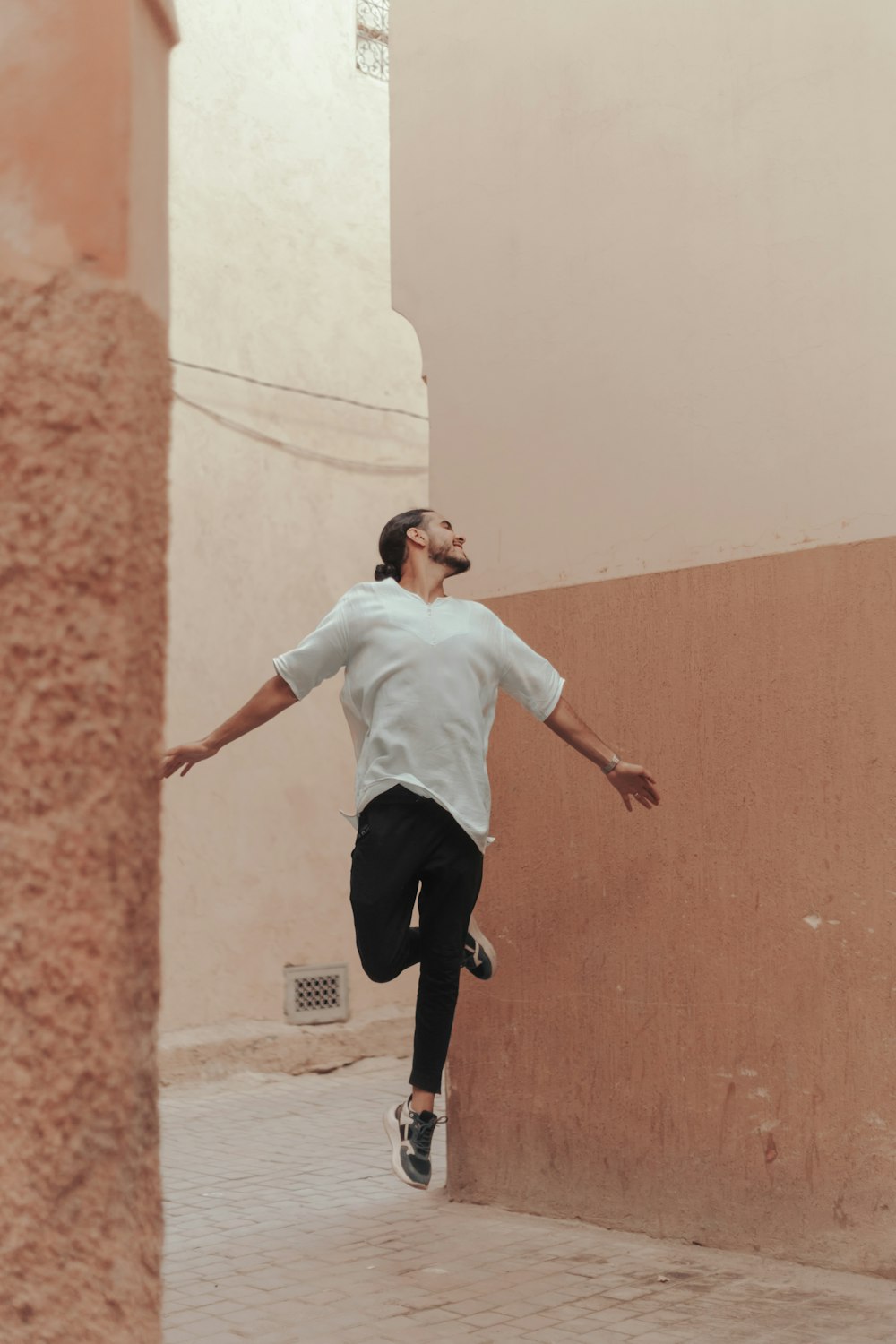 a man jumping between two walls
