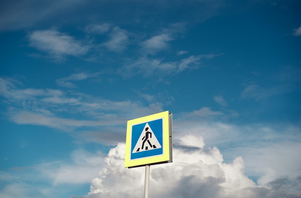 a sign with a blue sky in the background