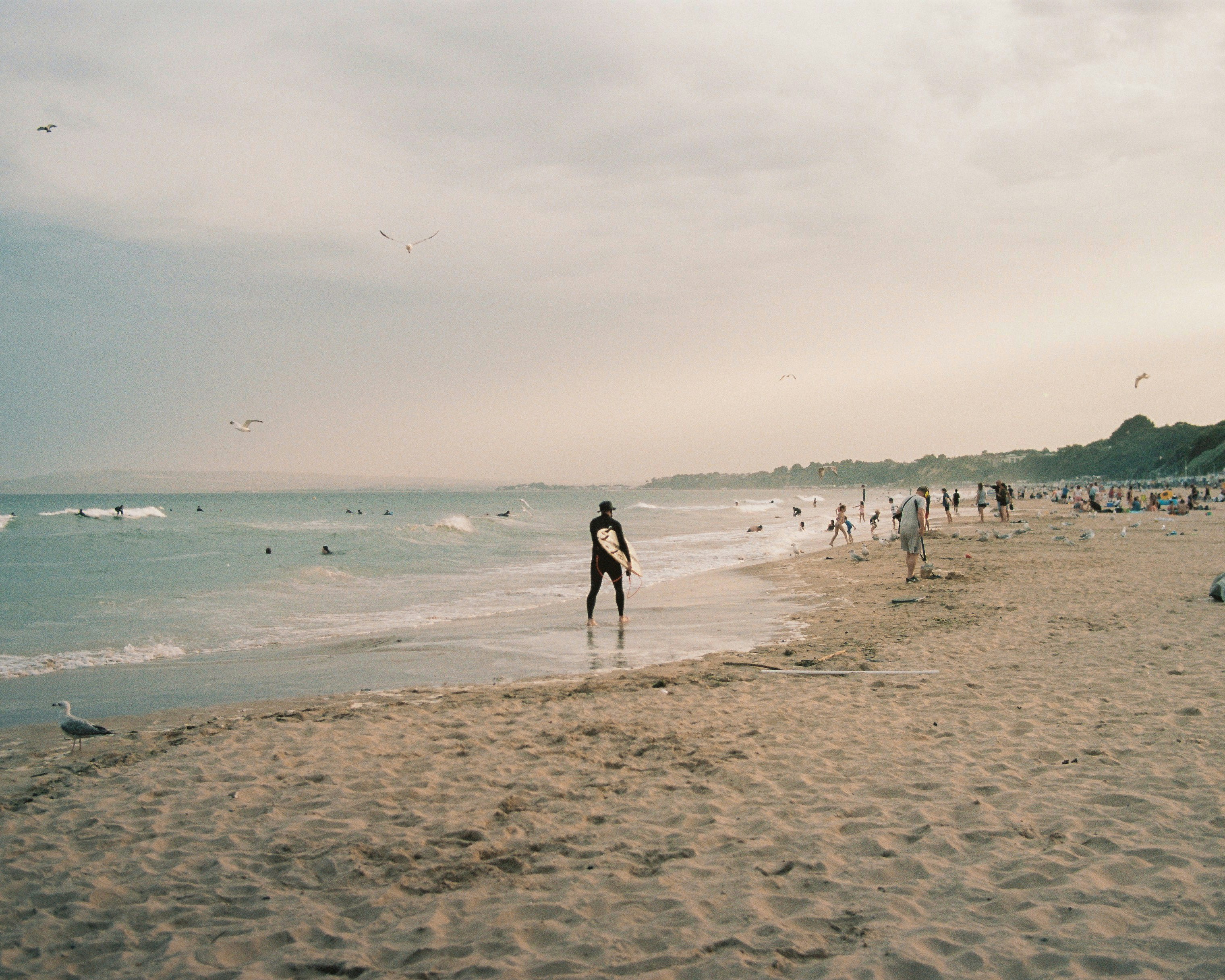 a person walks on the beach, Bournemouth Beach golden hour. 