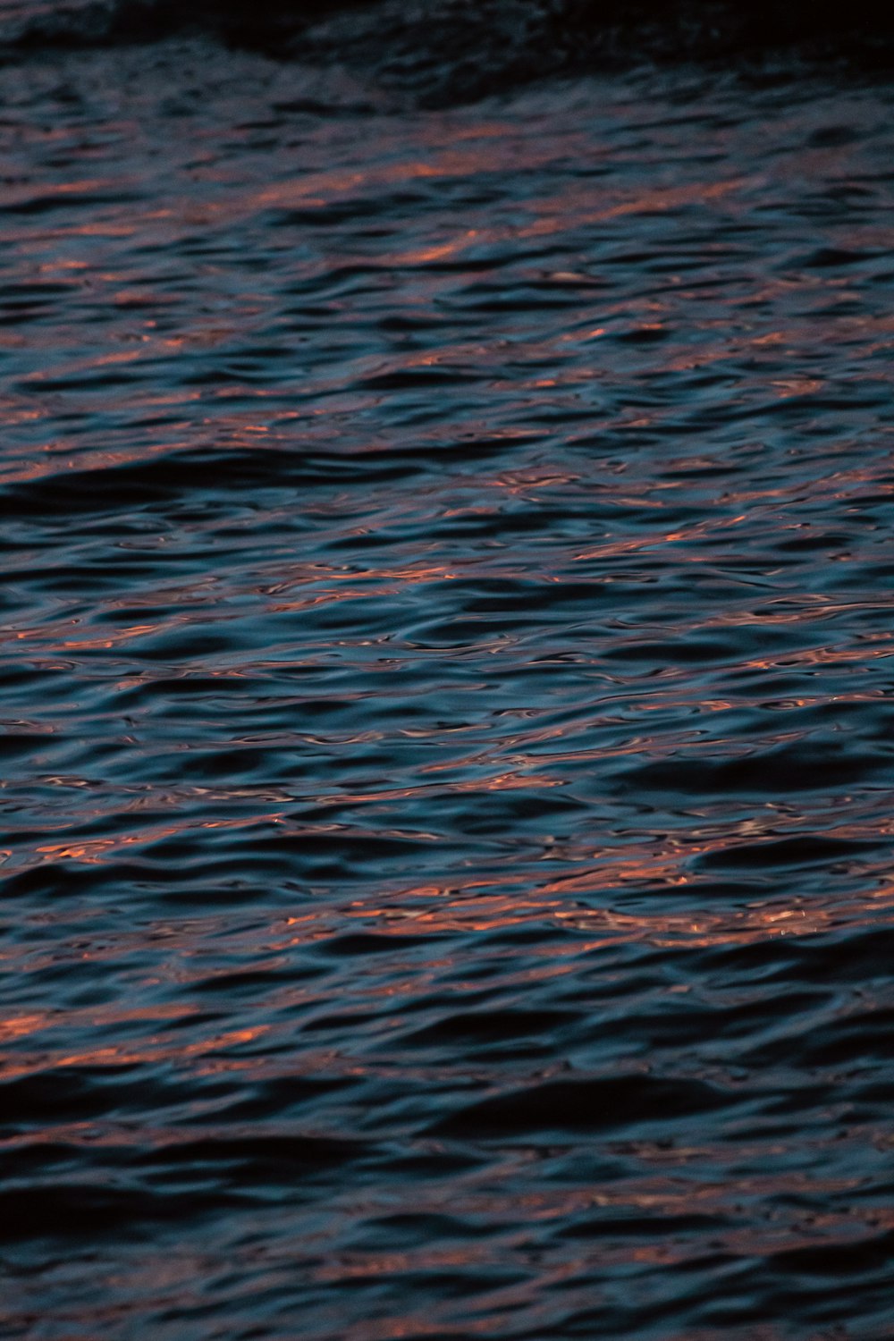 a body of water with a colorful sunset