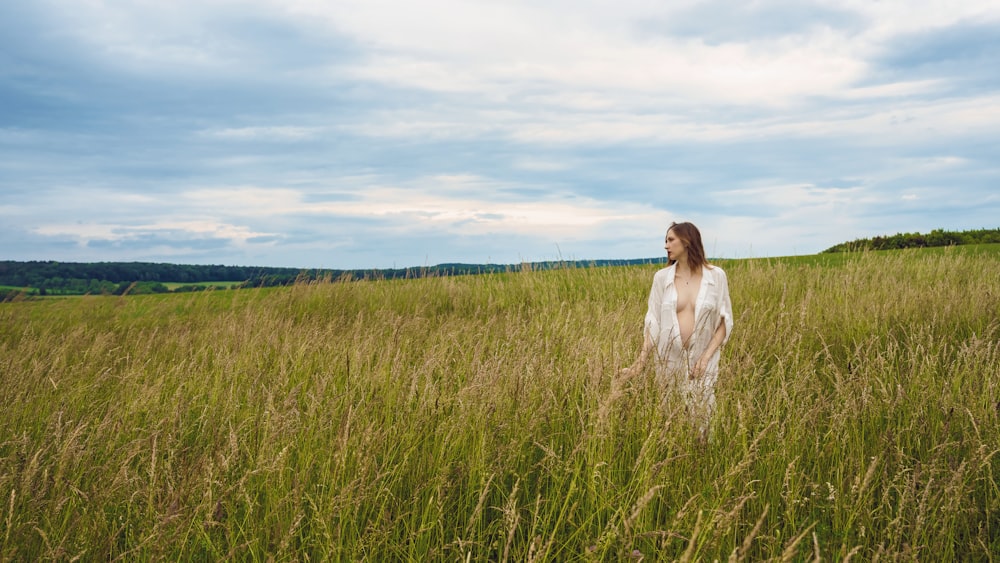 a person standing in a field of tall grass