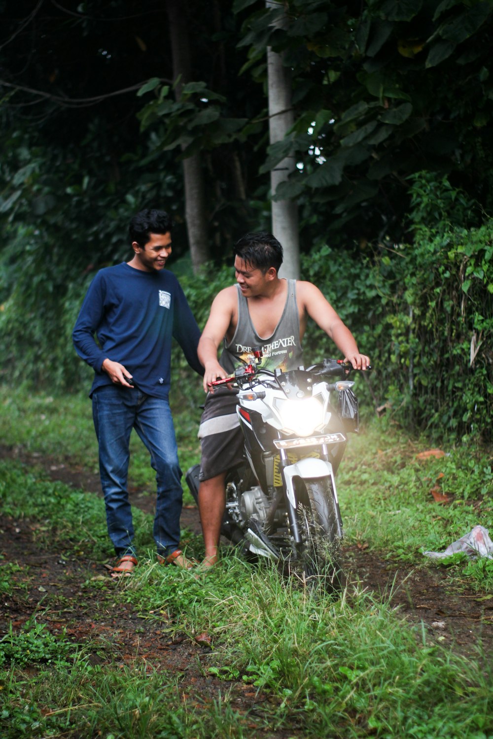 a man on a motorcycle being led by a man
