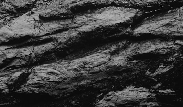 a black and white image of a rocky surfaceby José Ignacio Pompé