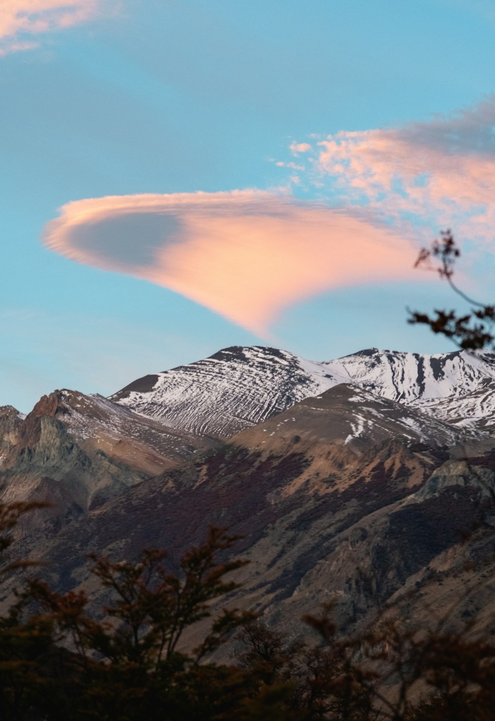 a snowy mountain with a blue sky