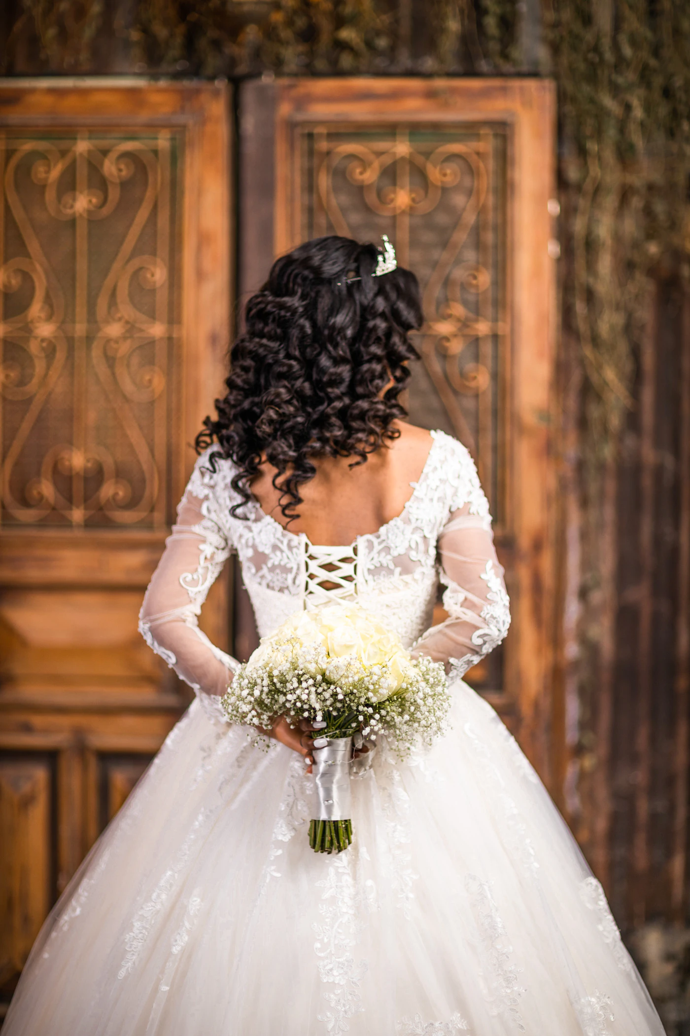 Modest wedding dress designs with long sleeves — A bridal boutique interior showing modest wedding gowns hanging on a rack.