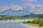 A serene landscape with a calm lake and mountains.