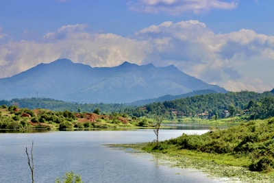 A serene landscape with a calm lake and mountains.