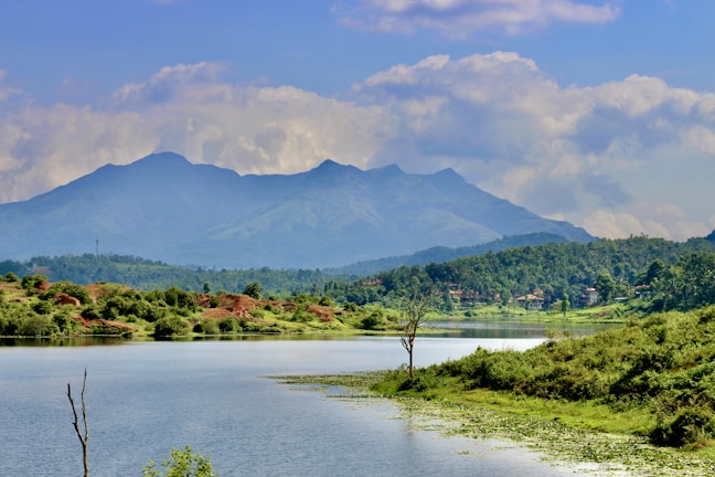 A serene landscape with a calm lake and mountains.