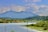 A serene landscape with a calm lake and mountains.