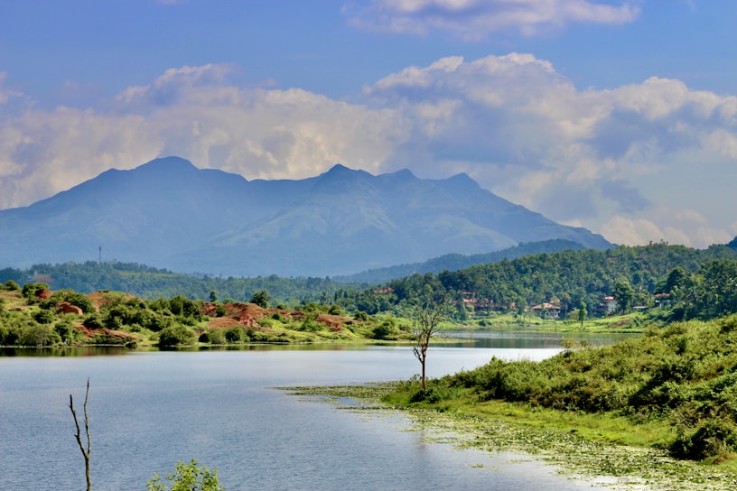 A serene landscape with a calm lake surrounded by mountains.
