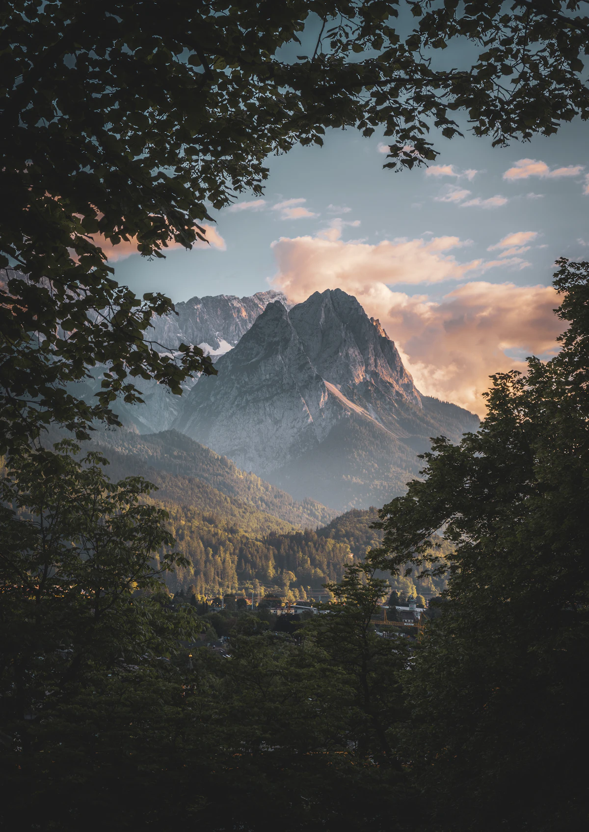 A rocky peak in evening light, seen through trees from Garmisch-Partenkirchen