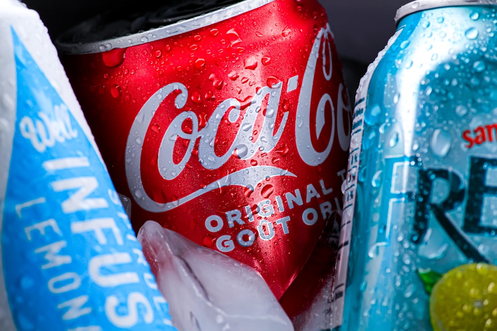 a hand holding a can of soda