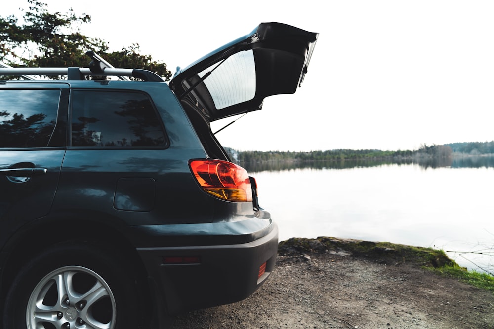 a car with its side facing a body of water