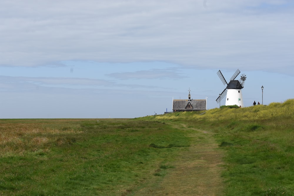 a group of windmills on a grassy hill