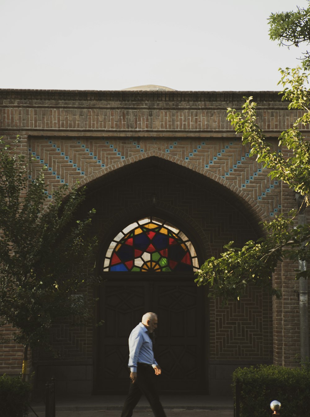 a person walking under a large arch