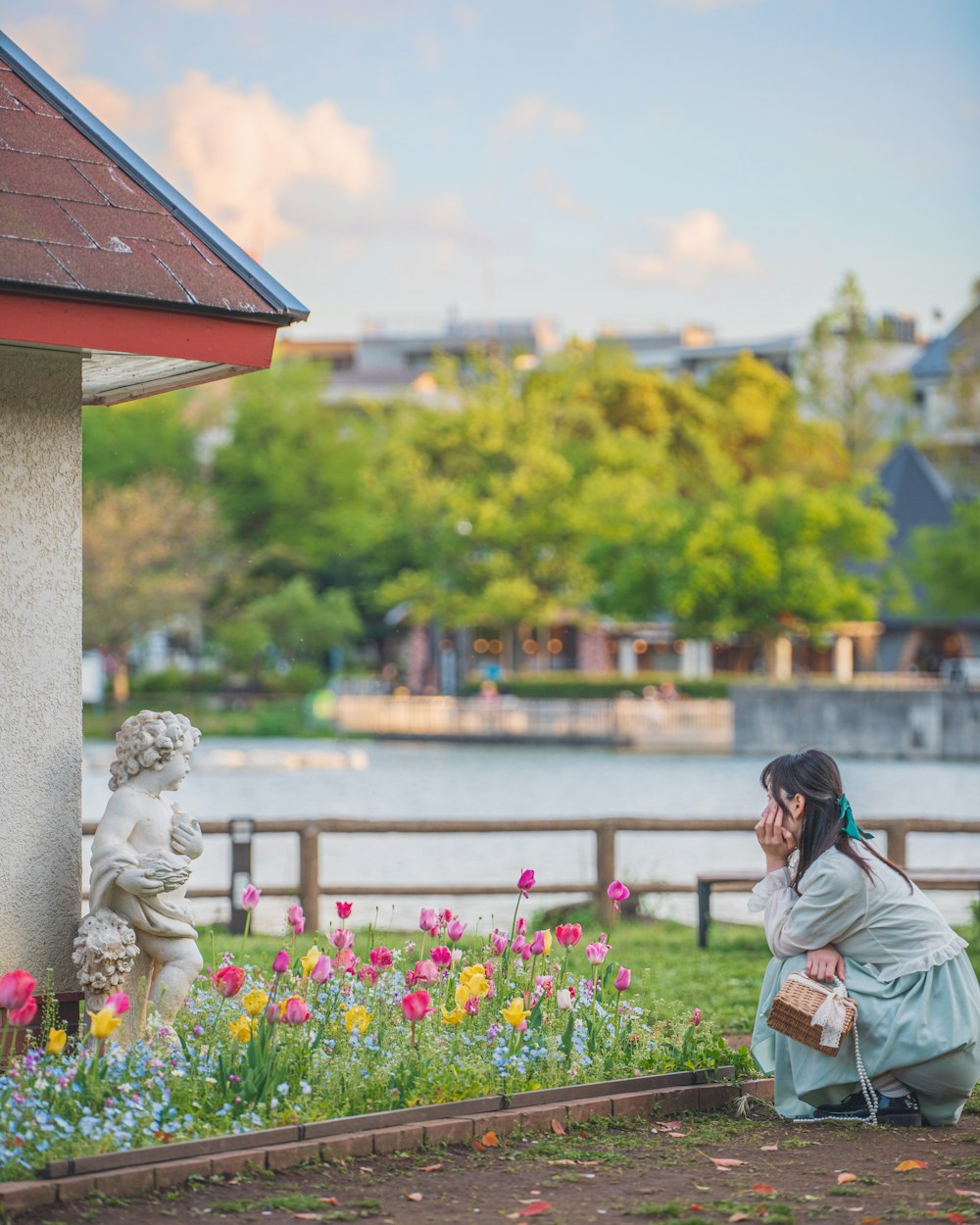 a woman sitting on a bench next to a statue of a man