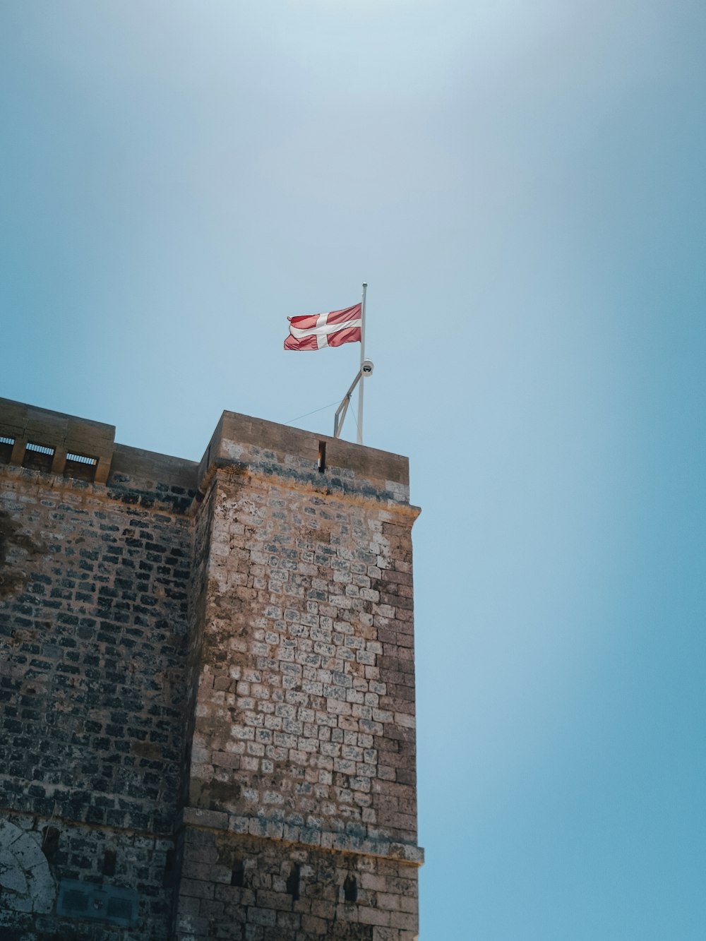 Un drapeau sur une tour de briques