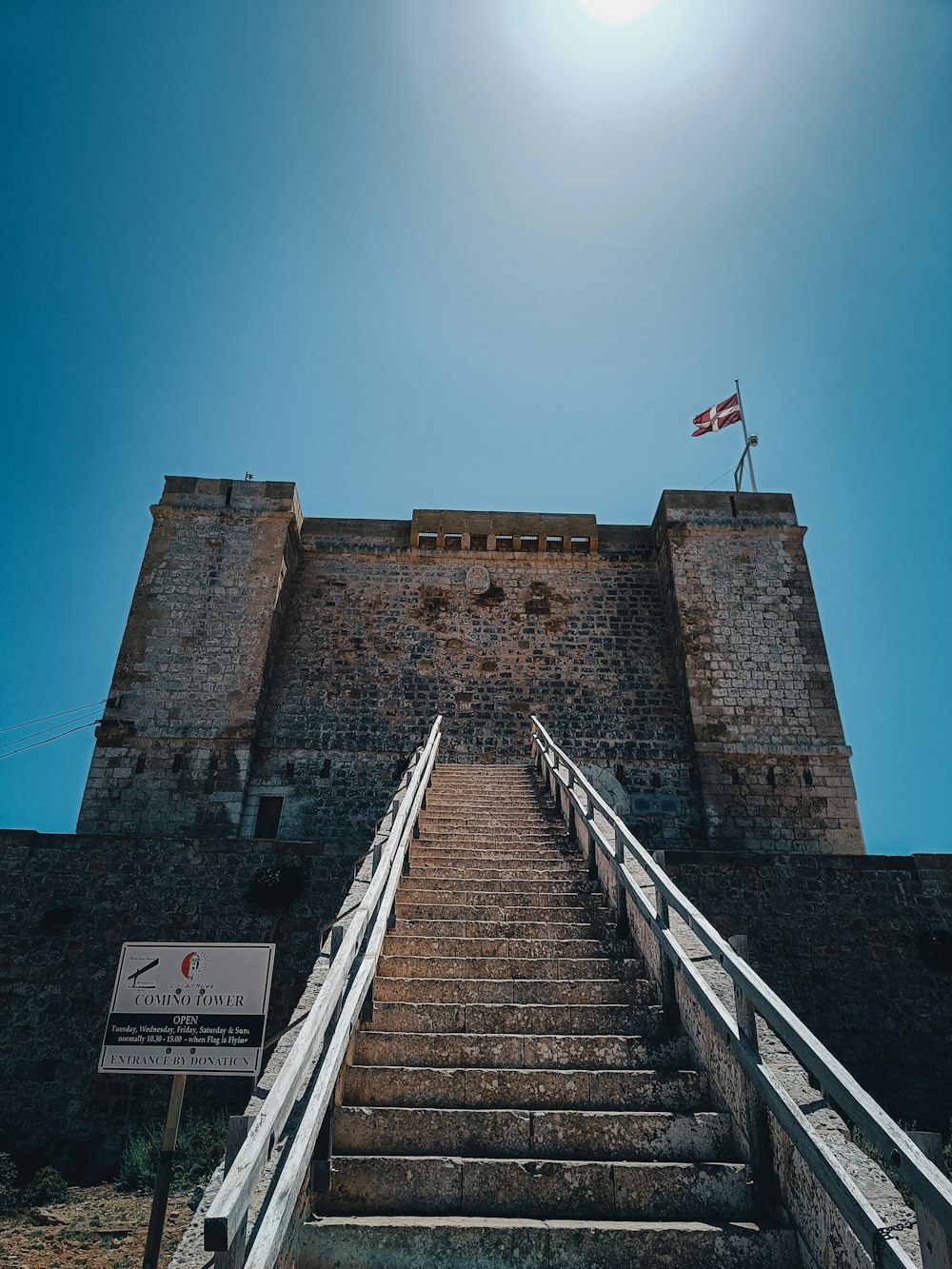 a stone castle with a flag on top