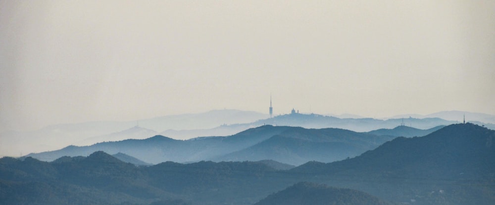 a mountain range with a tower