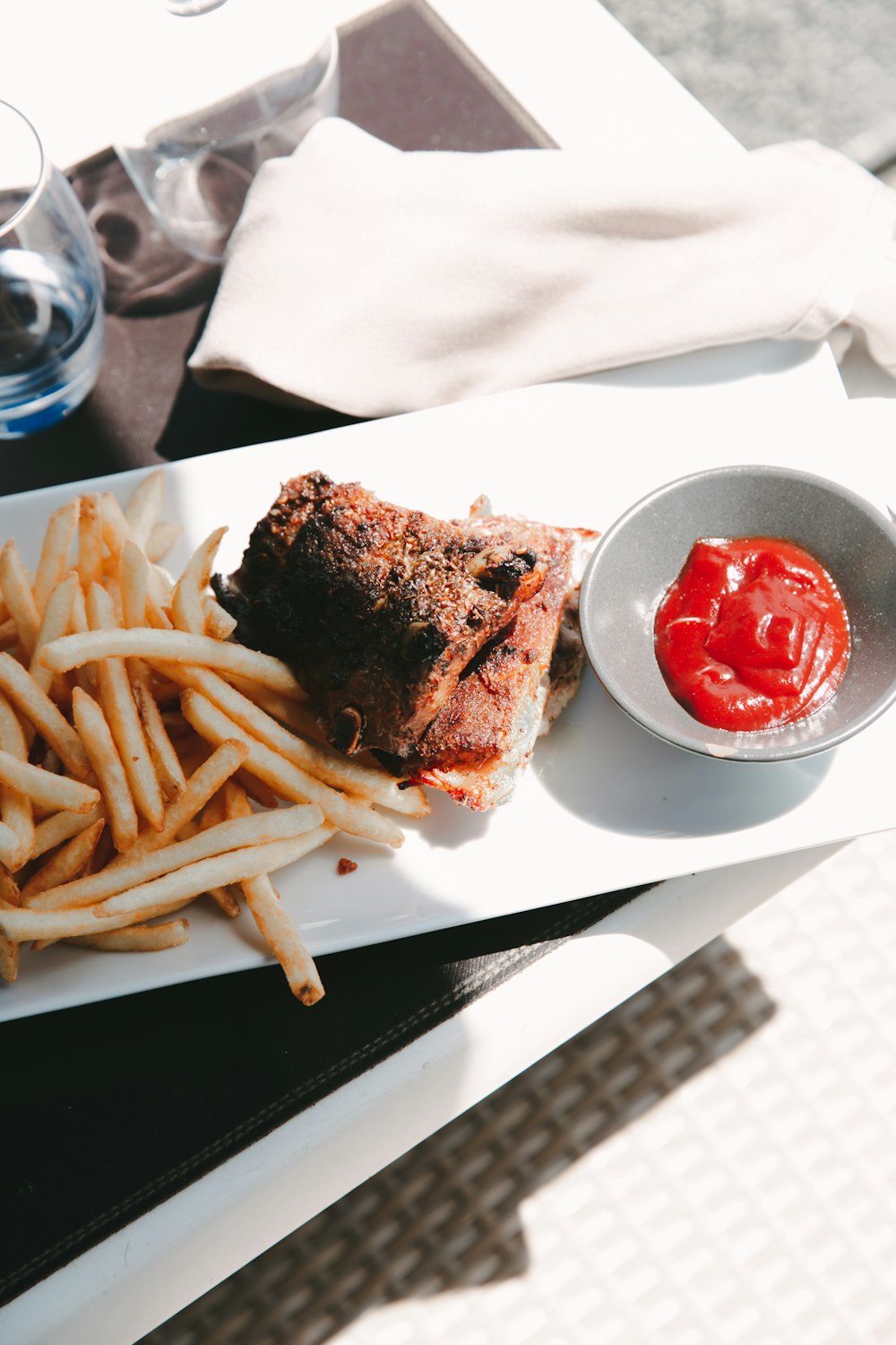 a plate of food and a bowl of fries